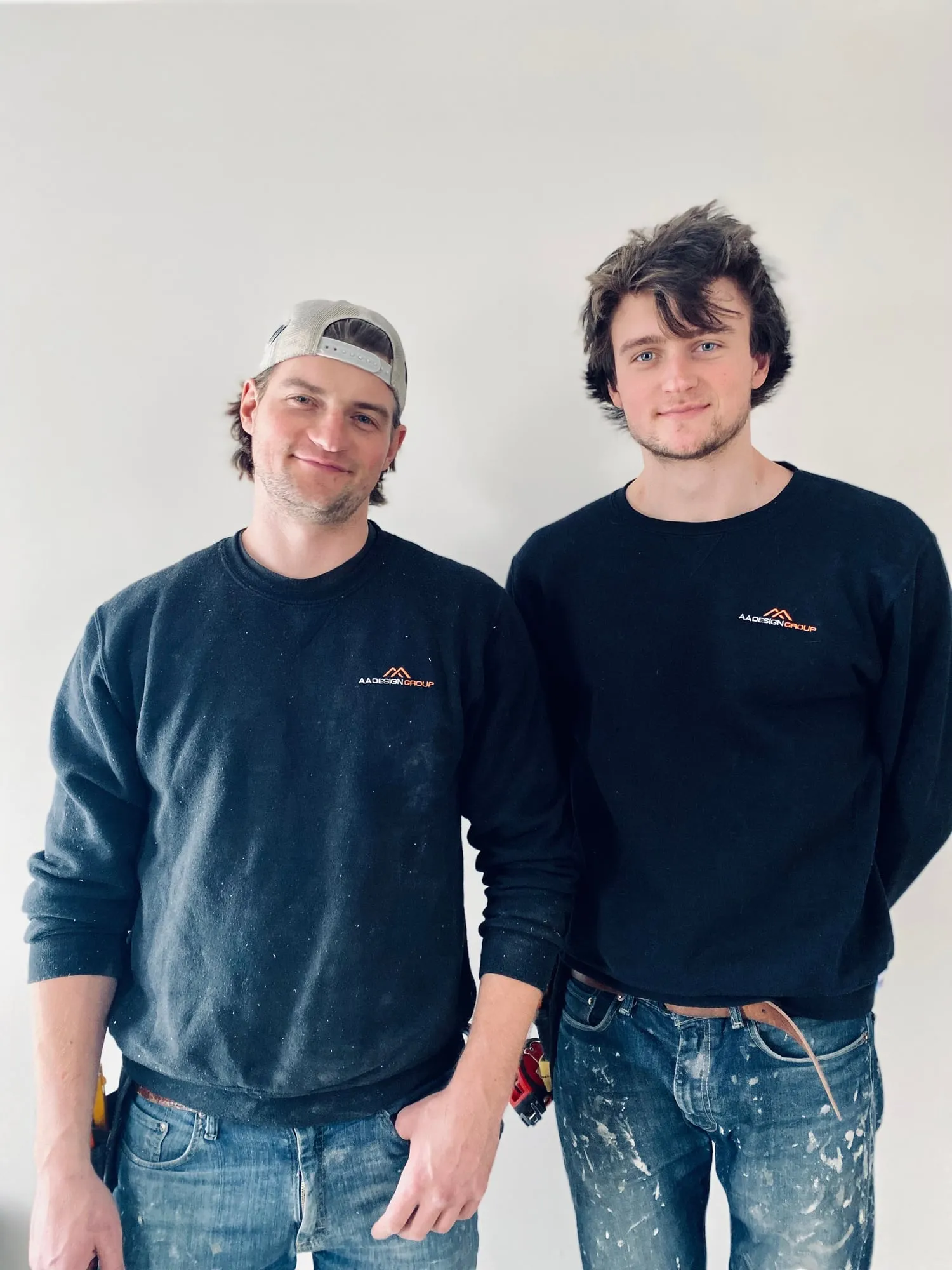 Vlad and Alex Aptovcov standing together in AA Design Group sweatshirts